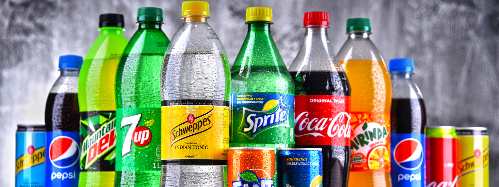 a group of soda bottles and cans