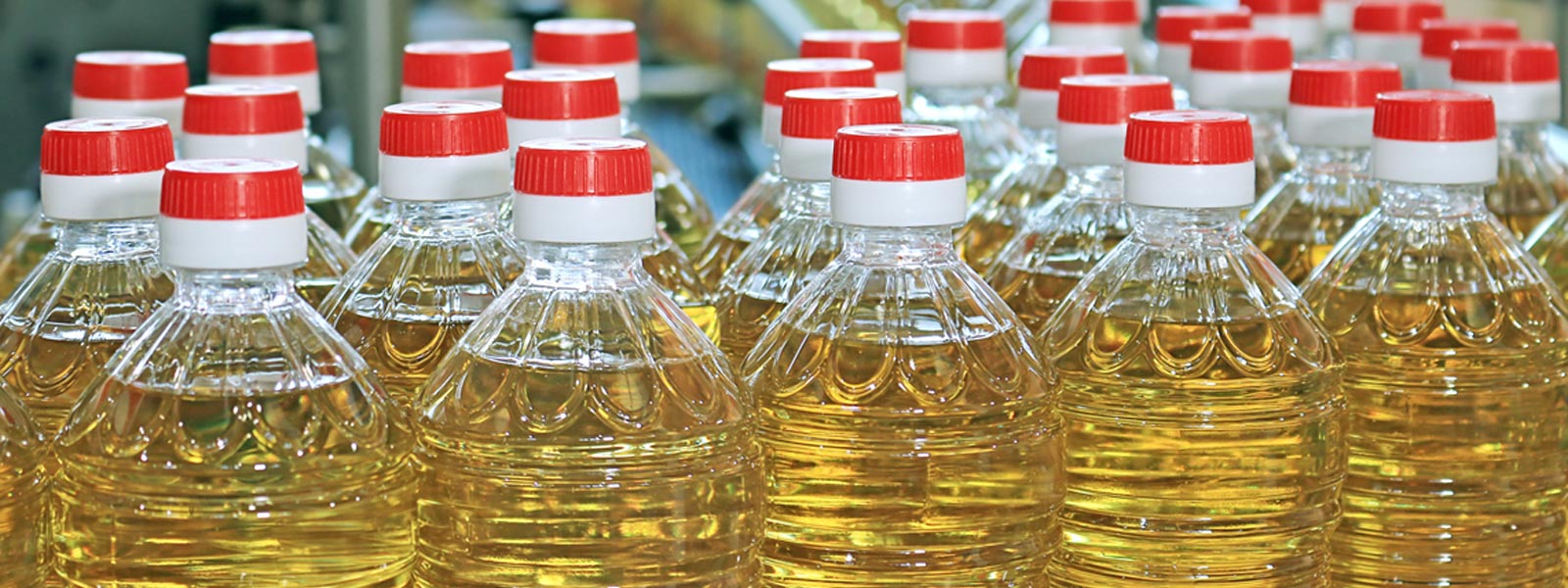 bottles of sunflower oil with red caps