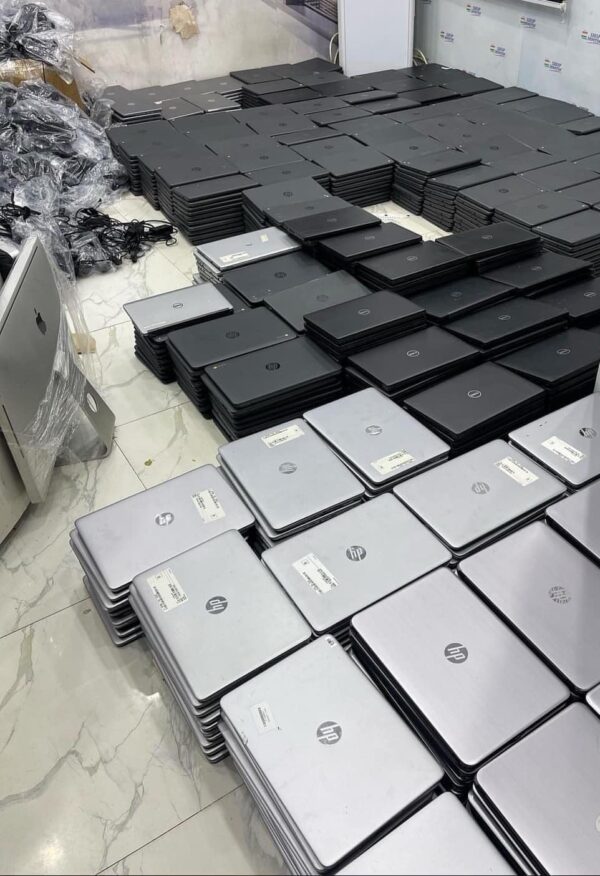 a stack of laptops on a floor