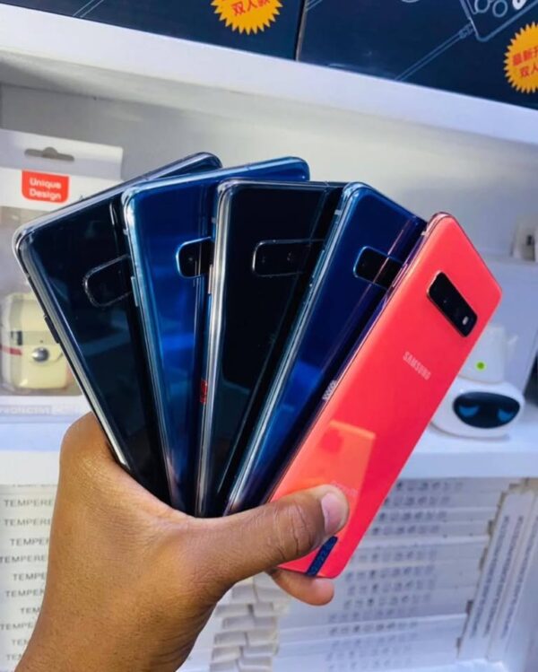 a hand holding a group of cell phones